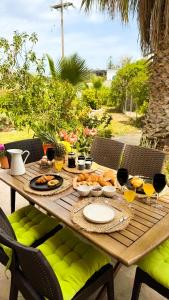 a wooden table with food and wine glasses on it at Casa Domenica in Zakynthos Town