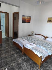 a bedroom with a bed in a room at Peristerianos apartments in Nea Skioni