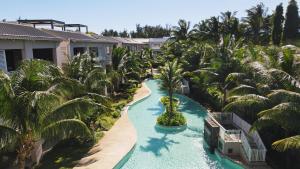 an aerial view of a resort pool with palm trees at Villa Eden-2 bedrooms with Private Rooftop Terrace & Pool & access to private beachclub, Ki Residences, Pereybère, Grand Baie in Grand Baie