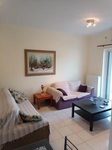 a living room with a couch and a coffee table at EVITA apartment in Preveza