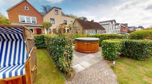 a garden with a bench and a large barrel at Appartement-Service-Laboe Haus Seewind in Laboe