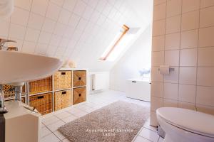 a bathroom with a sink and a toilet at Bellevue W10 in Laboe +16 photos