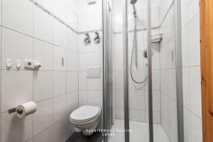 a white bathroom with a shower and a toilet at Stein W03 in Stein