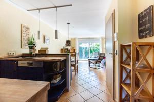 a kitchen with a counter and a dining room at Ostseeromantik in Neuhaus