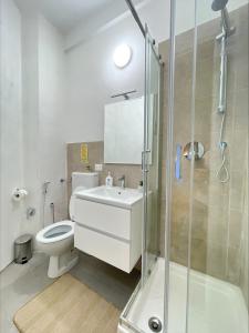 a bathroom with a toilet and a sink and a shower at Romoli Rooms and suites in Rome