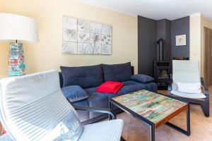 a living room with a blue couch and a table at Ostseeromantik in Neuhaus