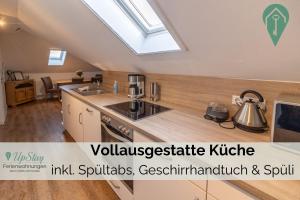 a kitchen with a sink and a stove top oven at Ferienwohnung Behle in Krummhörn