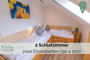 a room with two beds in a attic at Ferienwohnung Behle in Krummhörn