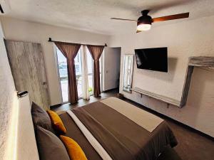 a bedroom with a bed and a flat screen tv at Huerto Don Antonio in Parras de la Fuente