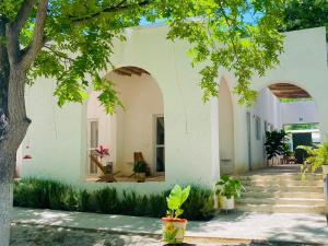 a white house with a tree and stairs at Huerto Don Antonio in Parras de la Fuente