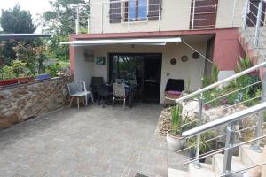 a patio of a house with a table and chairs at Maison Spacieuse Chamarande in Chamarande +5 photos