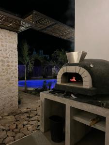 a stone oven with a fire in it at Campeche Mágico in Campeche