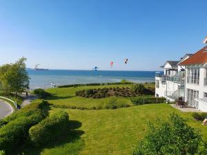 a house with people flying kites over the ocean at EdelStein in Stein