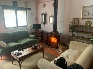 a living room with two couches and a fireplace at La Casina de Lucia in Merodio