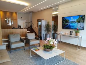 a lobby with two chairs and a table with flowers on it at Hotel Pepita Palace in Sinop