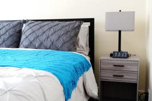 a bedroom with a bed and a nightstand with a lamp at Newly Renovated - Minutes from the City in Woodside