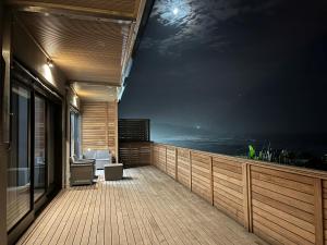 摩根湾Mitford The N I C E Condo的空甲板上摆放着桌子和椅子