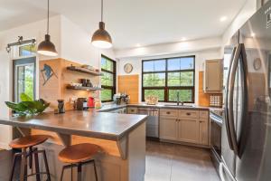 a kitchen with a large counter and a refrigerator at Tremblant Prestige - Les Eaux 235-1 in Mont-Tremblant
