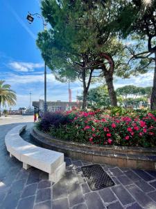 a park with a bench and flowers on a street at Nido tra castello e lago in Desenzano del Garda +16 photos
