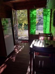 a kitchen with a refrigerator and a table and chairs at La Cabaña in Tandil
