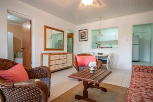 a living room with two chairs and a table at Aruba SunRise 1BR Rentals - San Nicolas in Sint Nicolaas