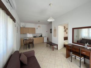 a living room and kitchen with a couch and a table at Koutrakis Rooms in Finikounta +55 photos