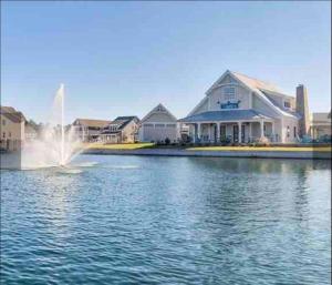 a fountain in the water in front of houses at Sparrows Nest 3br 2 and half bath beach cottage in Beaufort