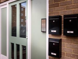 a pair of mail boxes on the side of a building at Vauxhall Apartments in Norwich +23 photos