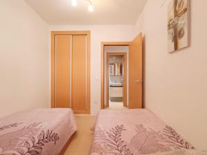 a bedroom with two beds and an open door at Ayf magníficas vista a la playa magic world in El Borseral +41 photos