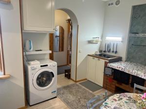 a laundry room with a washing machine and a sink at Papli Apartment near the Beach in Pärnu +5 photos