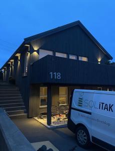 a white van parked in front of a building at Central leilighet i Kristiansand - Hellemyr in Kristiansand