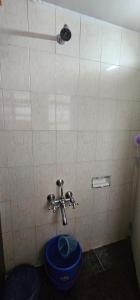 a bathroom with a blue toilet in a stall at Laxmi Happy Home in Pune in Pune