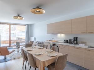 a kitchen with a table and chairs and a kitchen with a table and chairsktop at Appartement 2 pièces - Centre Vieil Alpe, parking inclus - FR-1-645-59 in LʼHuez +9 photos