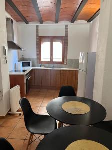 a kitchen with a table and chairs in a kitchen at Casa Cardona in Móra d'Ebre +31 photos