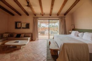 um quarto de hotel com uma cama e um sofá em Vestige Son Vell em Ciutadella