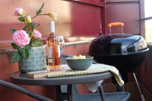 a table with a bottle of wine and flowers on it at CasaMarichelvas in San Asensio