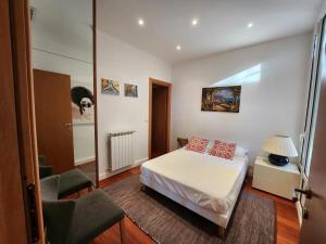 a small bedroom with a bed and a chair at Villa Bethanie in Villefranche-sur-Mer