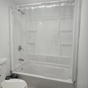 a white shower with empty shelves in a bathroom at Divine Villa Guest House Harper Ave EWR AIRPORT PENN STATION NY NJ in Irvington +24 photos
