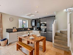 a kitchen with a wooden table and a counter top at 2 Bed in Great Ayton 75226 in Great Ayton