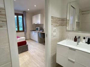 a white bathroom with a sink and a counter at RESORT Panoramico Canale Suite - private parking - Natural Park in Sinalunga