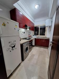 a kitchen with a white refrigerator and a dishwasher at Morocco House in Casablanca