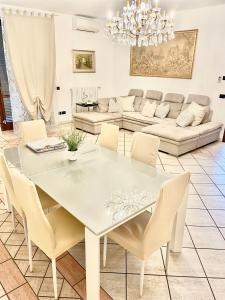 uma sala de jantar branca com uma mesa e cadeiras brancas em Villa near Milan & Rho Fiera em Gaggiano