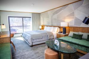 a hotel room with a bed and a couch at Banff Park Lodge in Banff