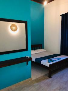 Un pat sau paturi într-o cameră la Kottamba Villa