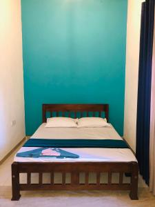 Un pat sau paturi într-o cameră la Kottamba Villa