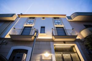 a building with balconies on the side of it at Palazzo De Gregorio Elegance Apartment in SantʼAntonio Abate