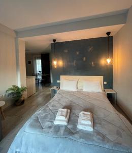 a bedroom with a large bed with two pillows on it at Panoramic suite in Kastoria