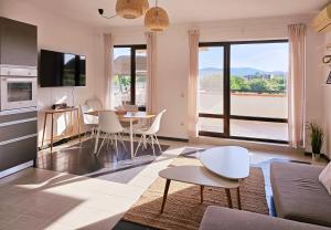 a kitchen and living room with a table and chairs at Sea Vacation Homes in Chernomorets