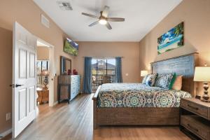 a bedroom with a bed and a ceiling fan at Bahama Bay Huge Penthouse condo in Kissimmee