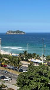 vistas a una playa con palmeras y al océano en Vista para o mar Barra da tijuca, en Río de Janeiro